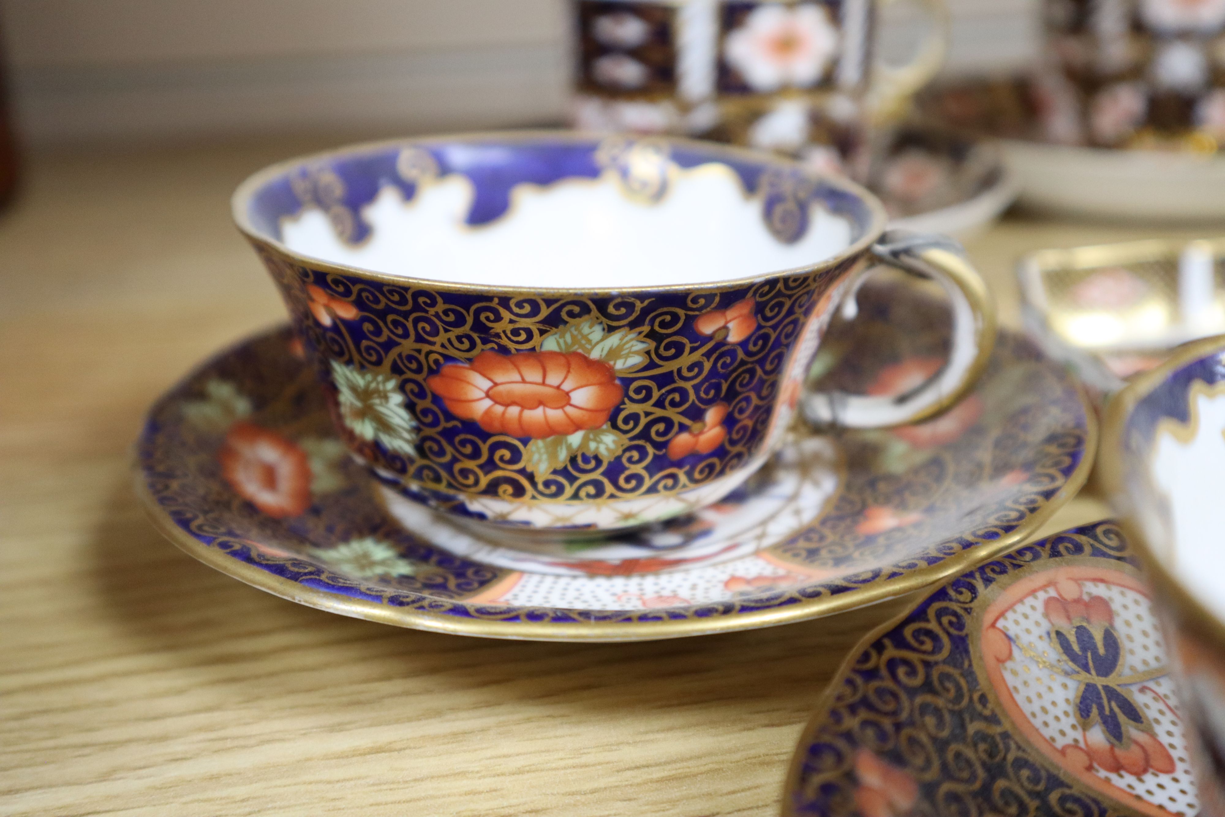 A collection of six Royal Crown Derby cups and saucers, a small square trinket dish and a miniature cup and saucer (16)